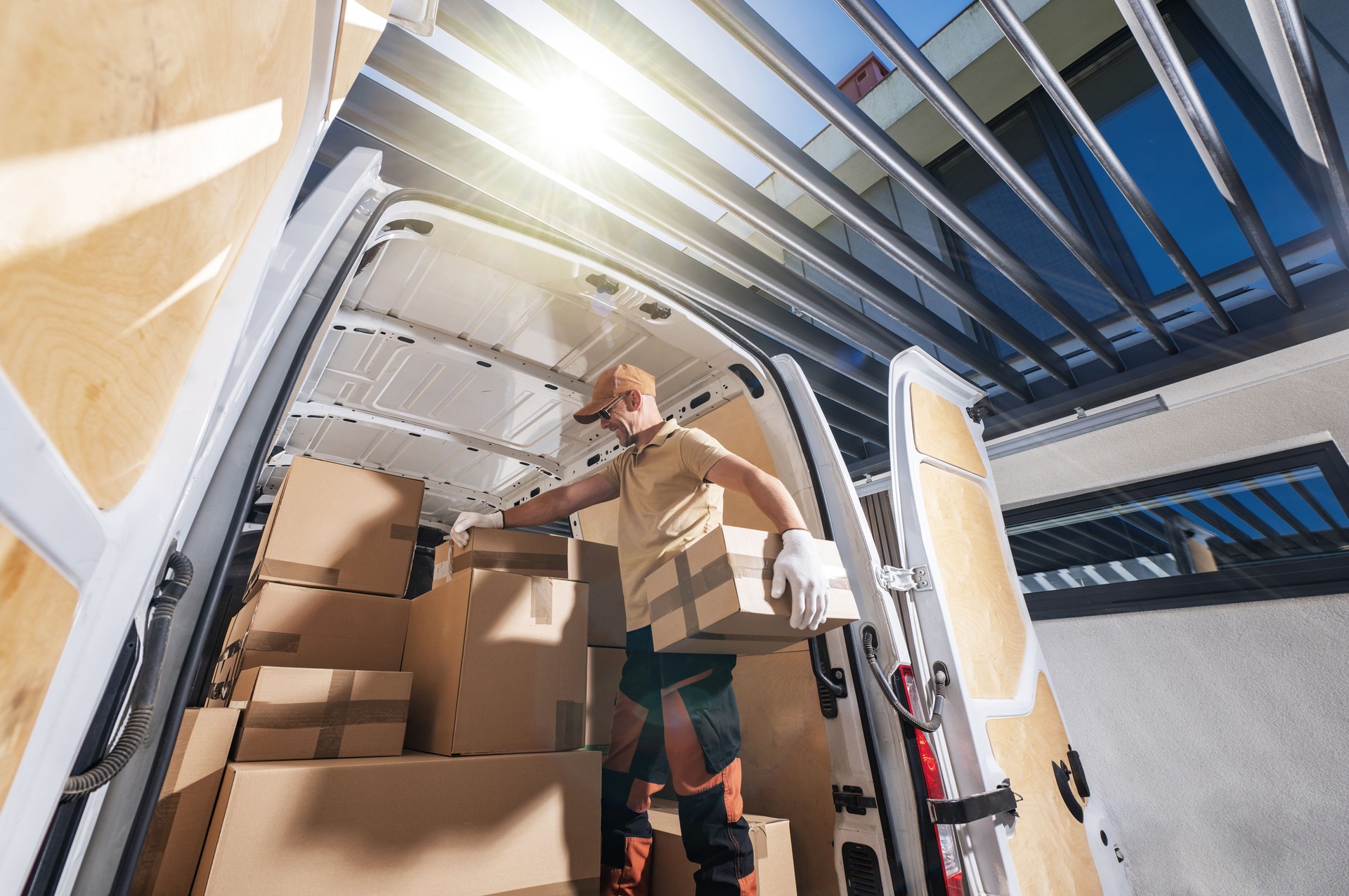 Courier Loading Boxes Into Moving Van